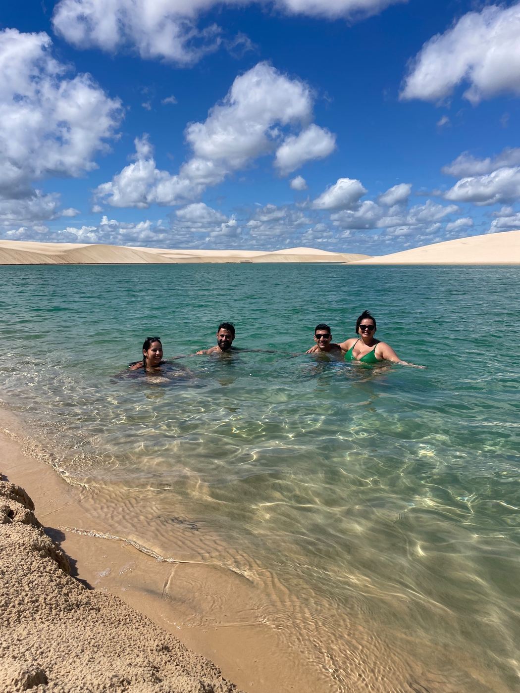 Amigos se banhando em lagoa cristalina